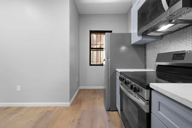 a kitchen with granite countertop a stove and a microwave
