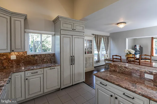 a kitchen with stainless steel appliances granite countertop a refrigerator and a sink