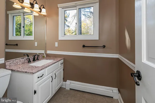 a bathroom with a sink a vanity and a window
