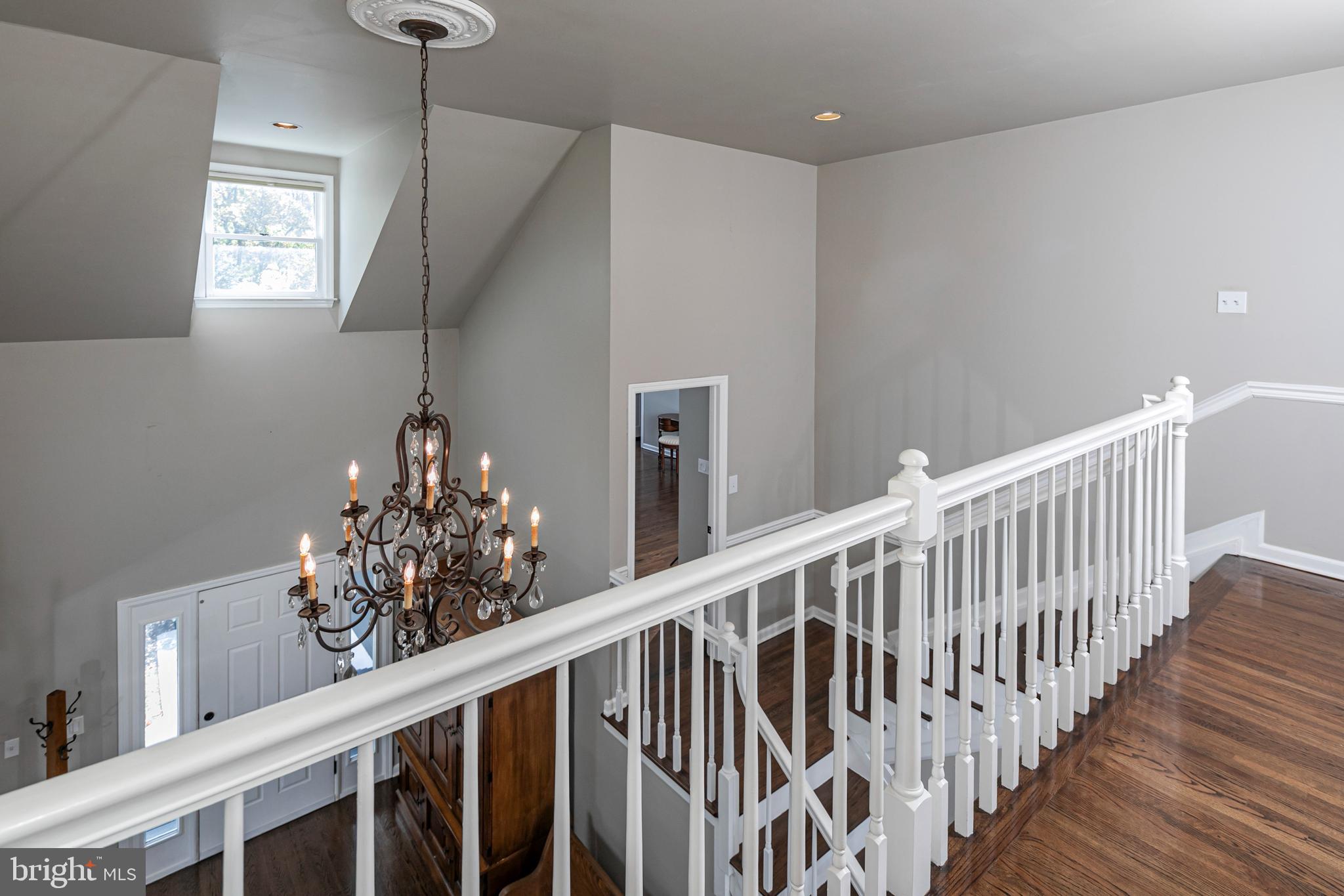 45 Willow Road Lawrenceville, NJ 08648 - Photo 20 of 32 a view of a hallway with wooden floor and chandelier