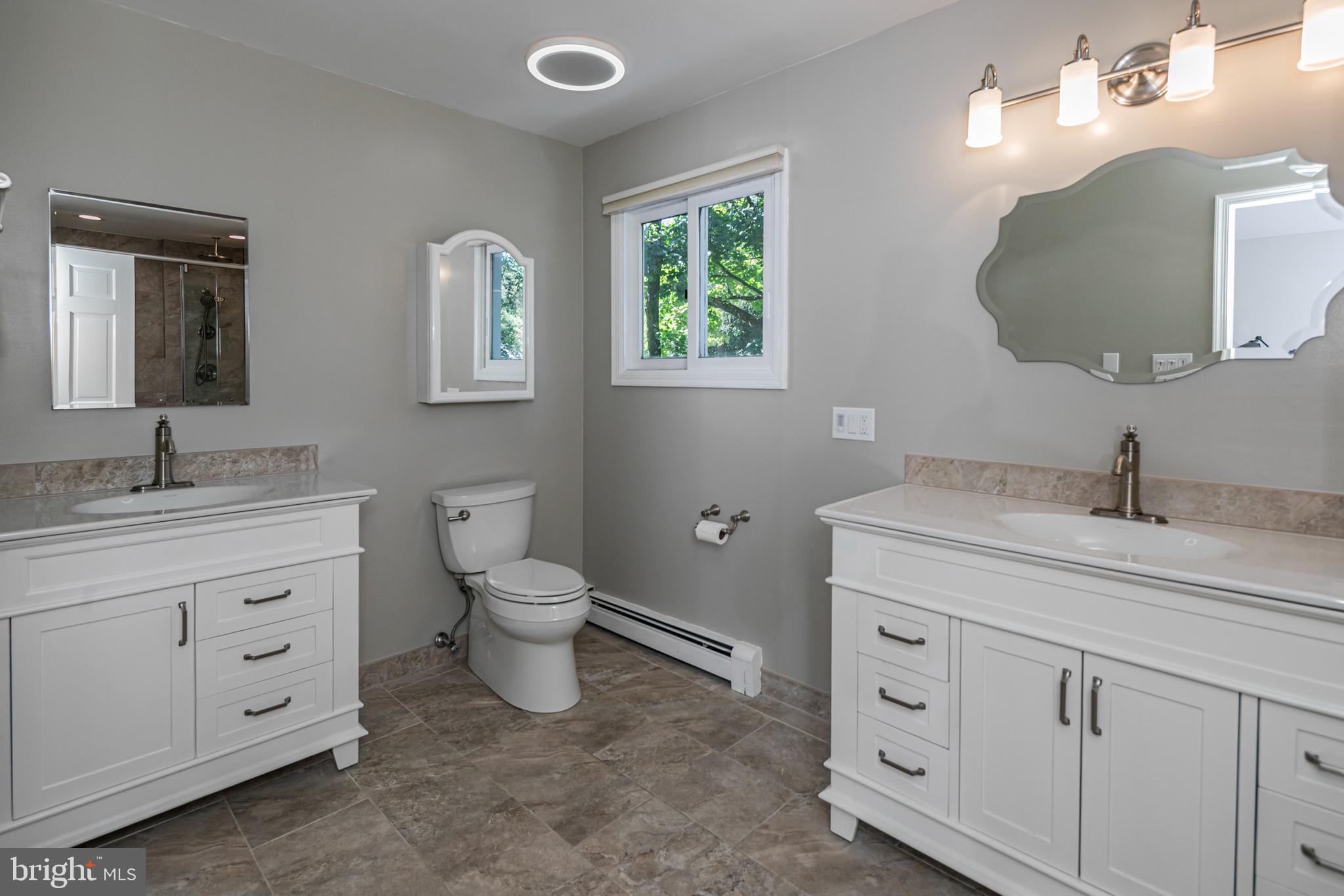 45 Willow Road Lawrenceville, NJ 08648 - Photo 23 of 32 a bathroom with 2 sink toilet and a mirror
