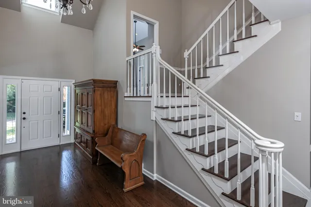 a view of entryway with wooden floor and stairs