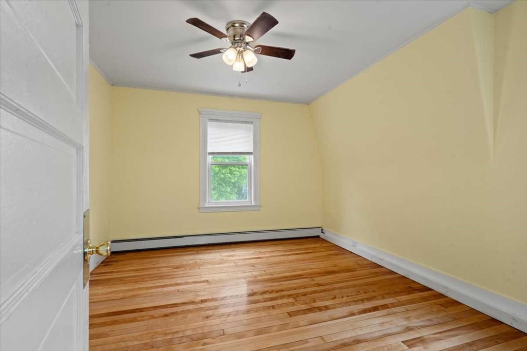 3 Wallace Street Worcester, MA 01605 - Photo 14 of 29 a view of an empty room with wooden floor and a window
