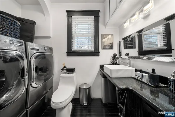 a bathroom with a sink a toilet and a window