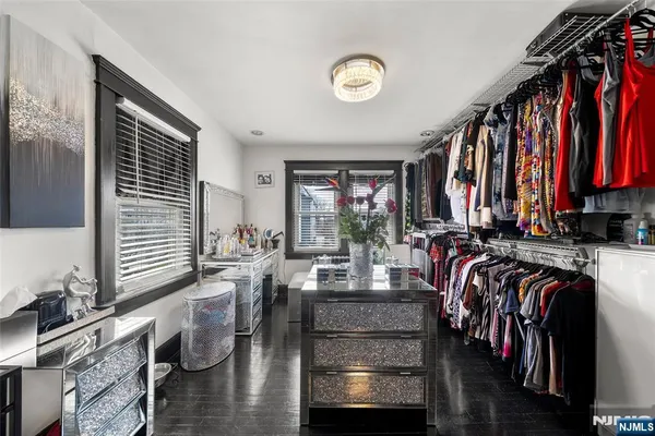 a bathroom with a sink a toilet a mirror and a window