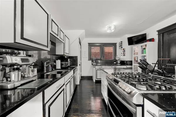 a kitchen with stainless steel appliances a sink dishwasher stove and refrigerator