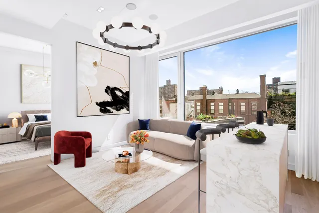 a living room with furniture and a chandelier