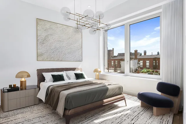 a bedroom with a large bed and a window