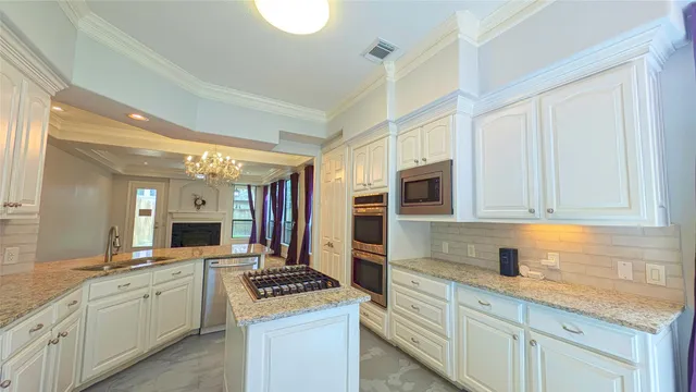 a kitchen with stainless steel appliances granite countertop a stove and a sink