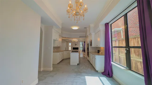 a view of a kitchen with a sink and dishwasher a refrigerator with a dining table