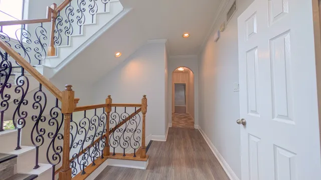 a view of entryway with stairs and wooden floor