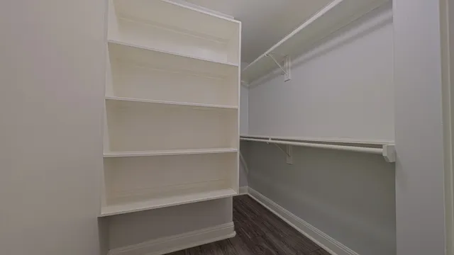 a view of walk in closet with empty racks