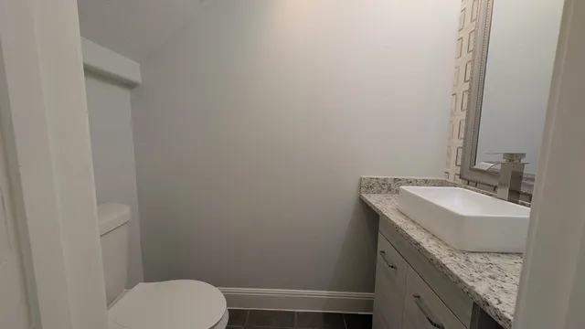 a bathroom with a sink toilet and vanity