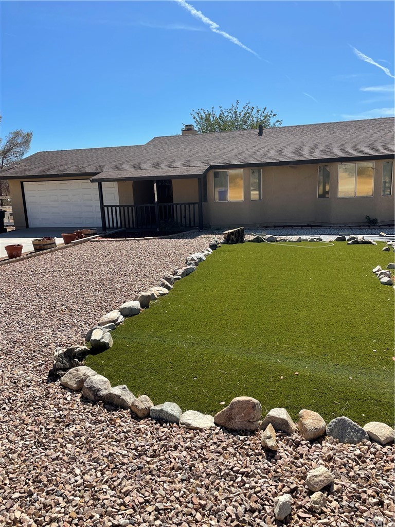14830 Desert Star Road Apple Valley, CA 92307 - Photo 1 of 1 a front view of a house with garden