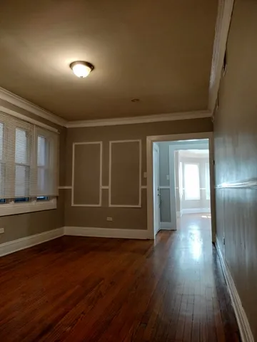 a view of wooden floor and windows in an empty room