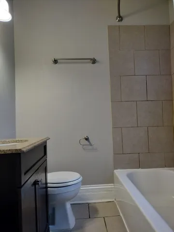 a bathroom with a sink a toilet and bathtub