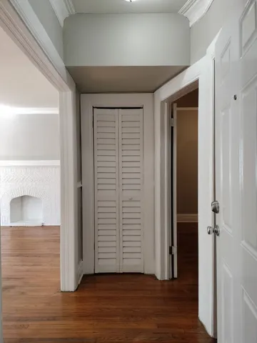 an empty room with wooden floor and closet