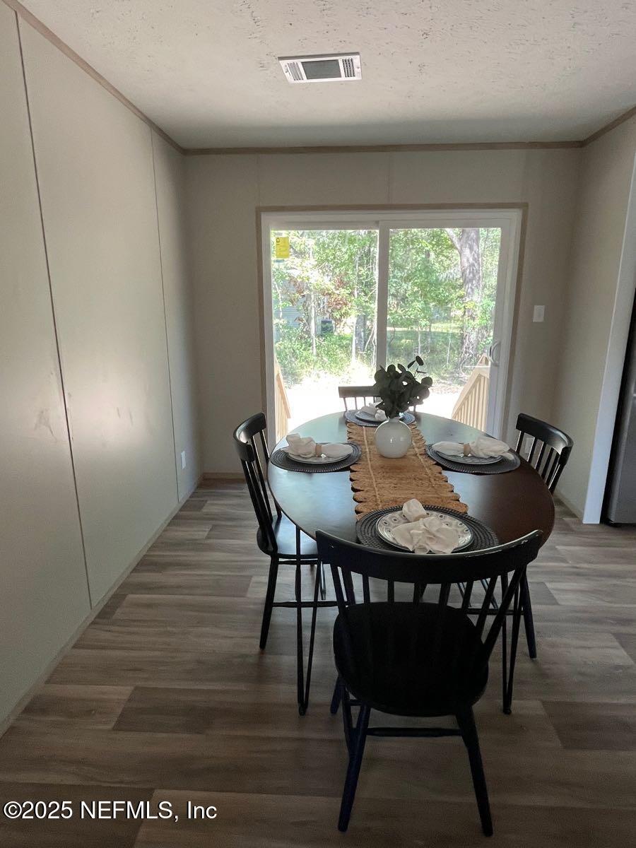 45692 Jones Way Callahan, FL 32011 - Photo 13 of 31 a view of a dining room with furniture window and wooden floor