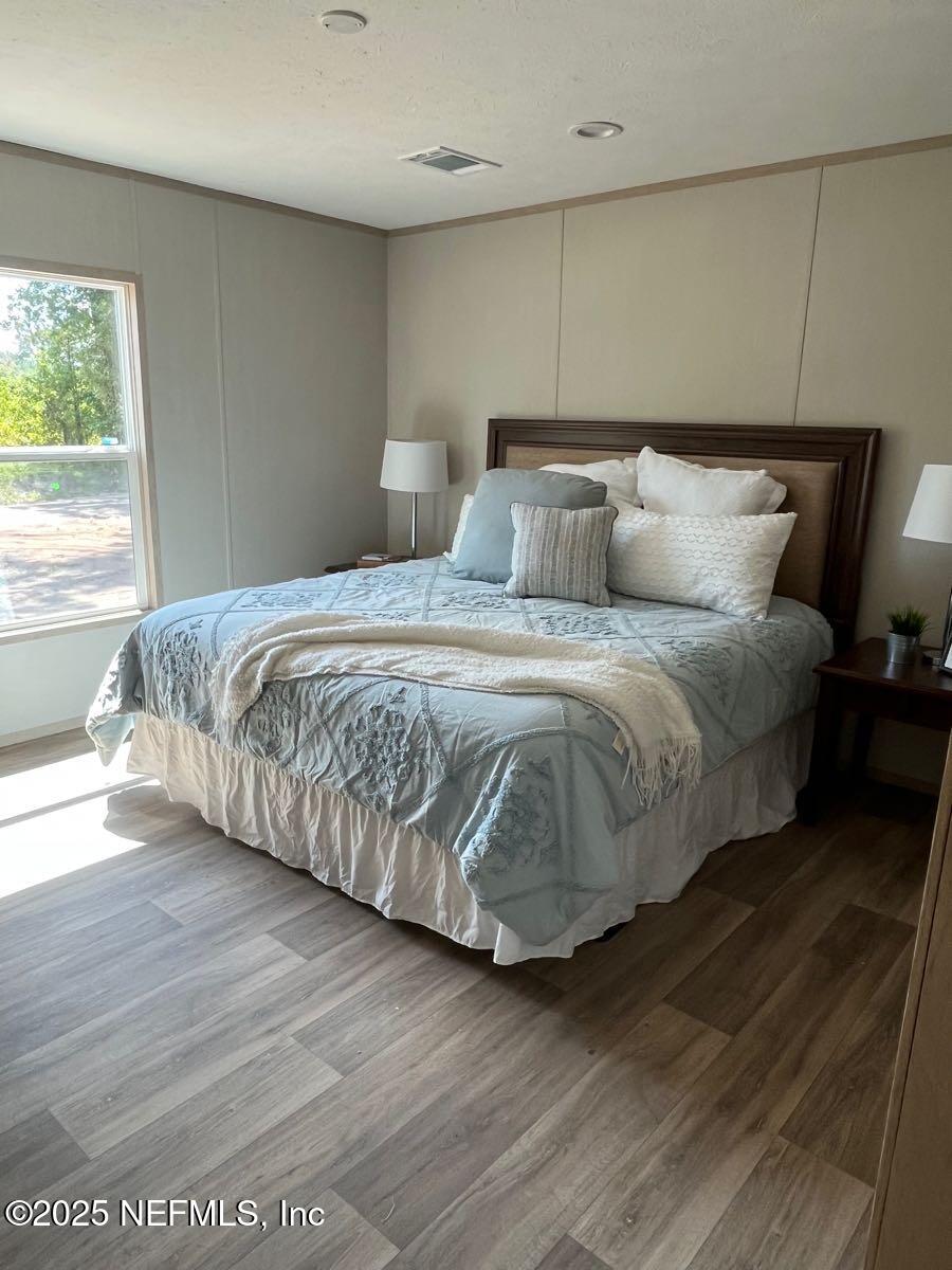 45692 Jones Way Callahan, FL 32011 - Photo 14 of 31 a bedroom with bed and window