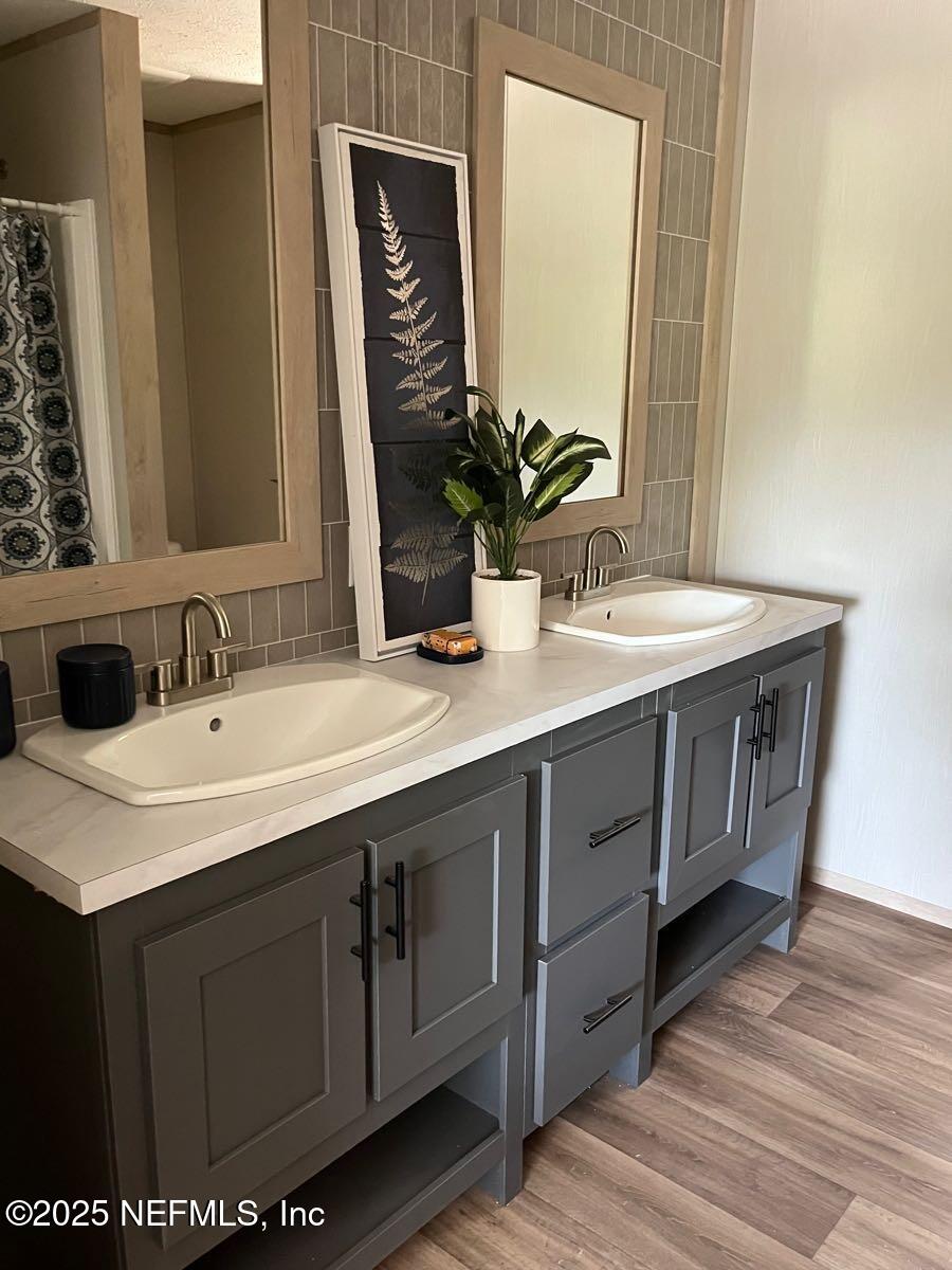 45692 Jones Way Callahan, FL 32011 - Photo 17 of 31 a bathroom with a sink and a mirror