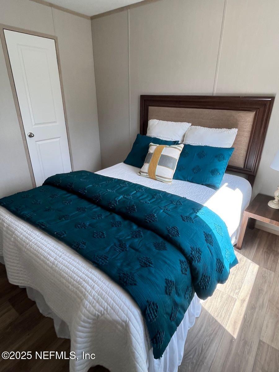 45692 Jones Way Callahan, FL 32011 - Photo 22 of 31 a bed sitting in a bedroom next to a cabinet