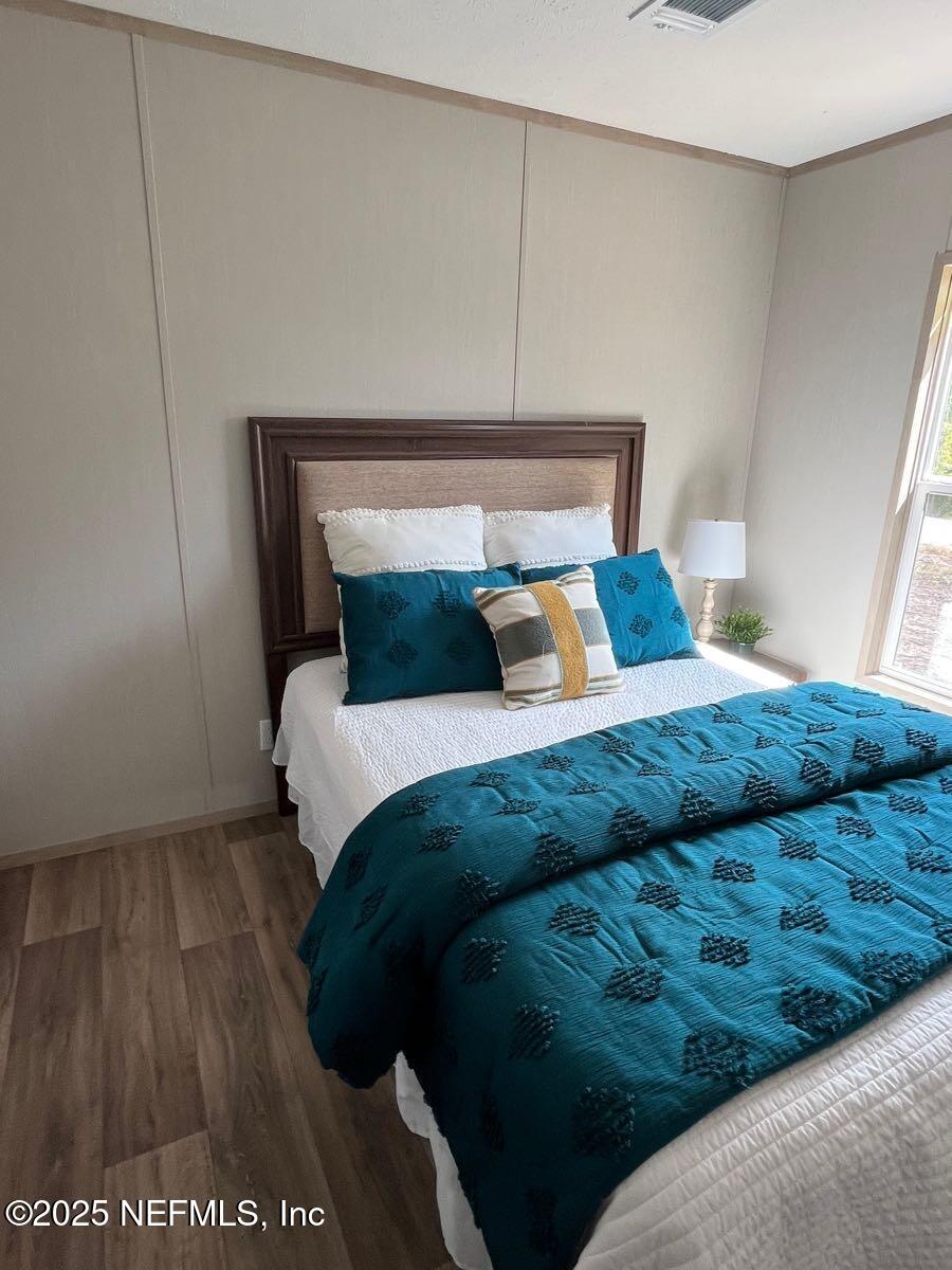 45692 Jones Way Callahan, FL 32011 - Photo 23 of 31 a bedroom with a bed and a night stand