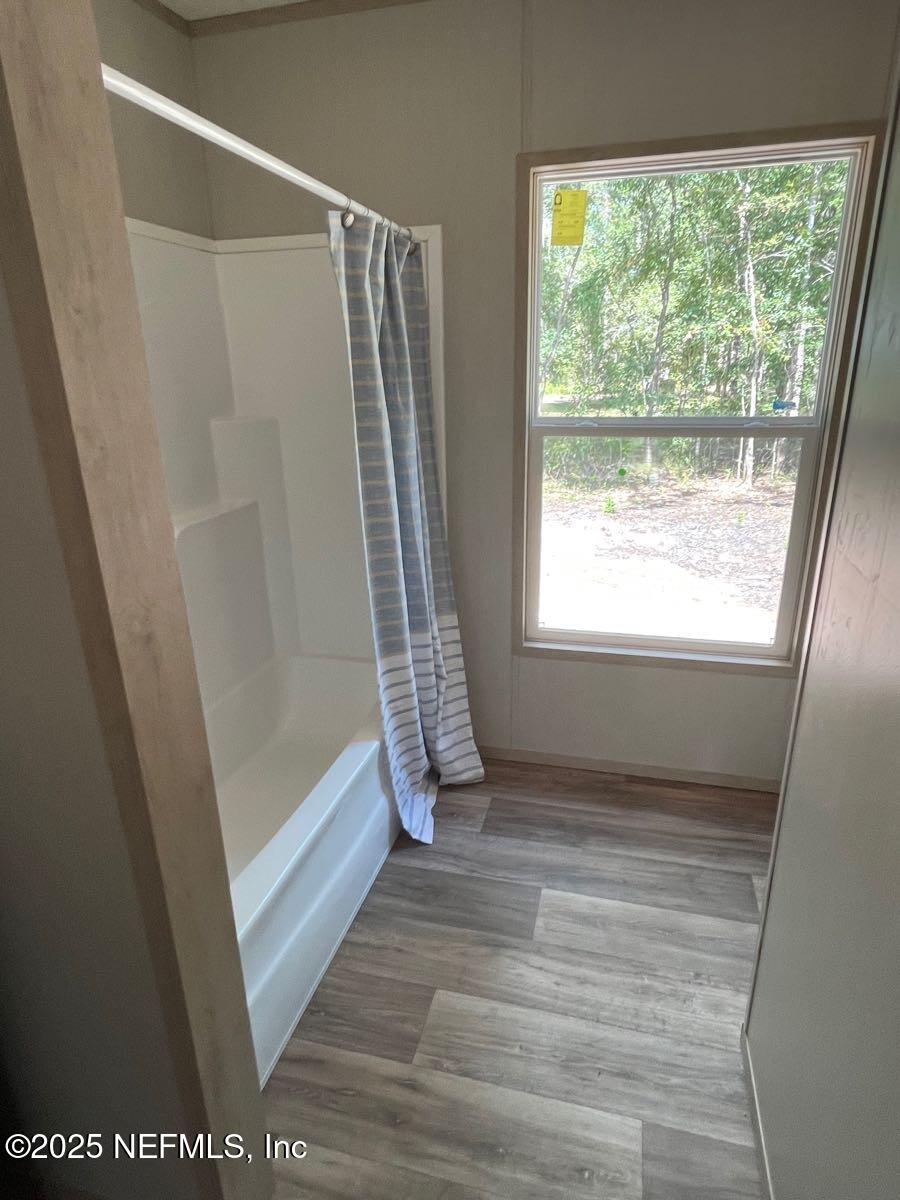 45692 Jones Way Callahan, FL 32011 - Photo 24 of 31 a view of bathroom with bathtub and window