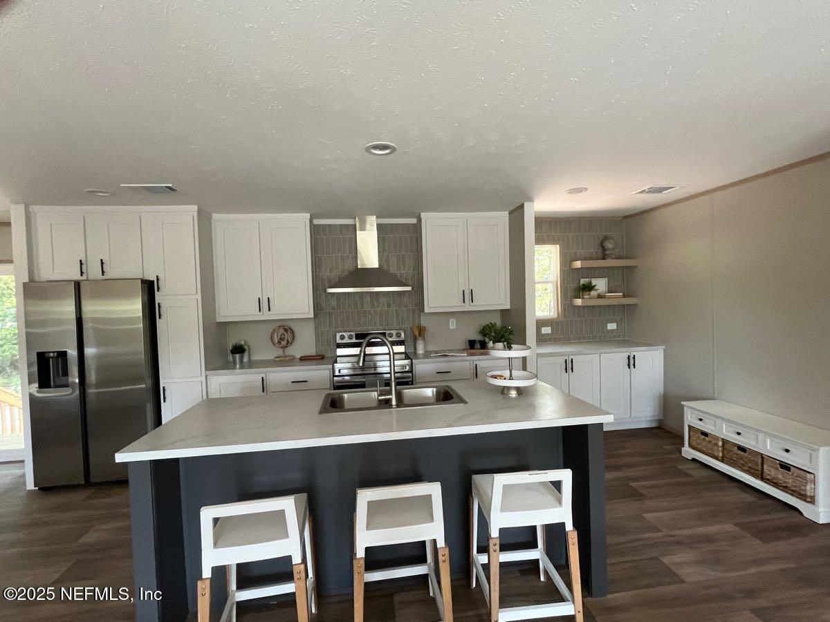 45692 Jones Way Callahan, FL 32011 - Photo 5 of 31 a kitchen with a sink cabinets and stainless steel appliances