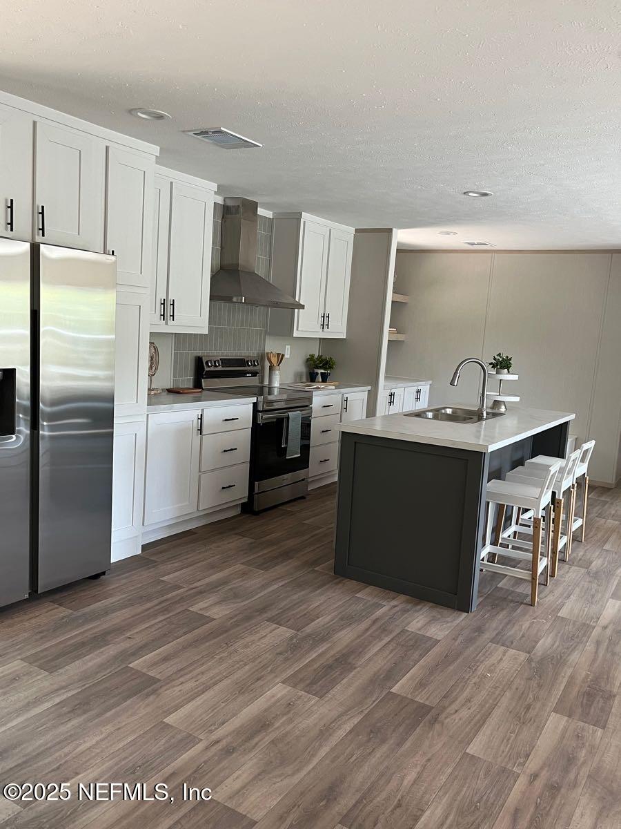 45692 Jones Way Callahan, FL 32011 - Photo 7 of 31 a kitchen with kitchen island granite countertop a sink stove and refrigerator