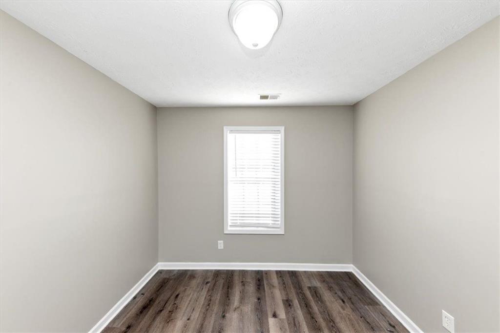 4169 Riverbank Court Decatur, GA 30034 - Photo 15 of 32 an empty room with wooden floor and windows