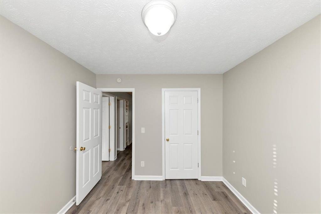 4169 Riverbank Court Decatur, GA 30034 - Photo 16 of 32 an empty room with wooden floor and windows