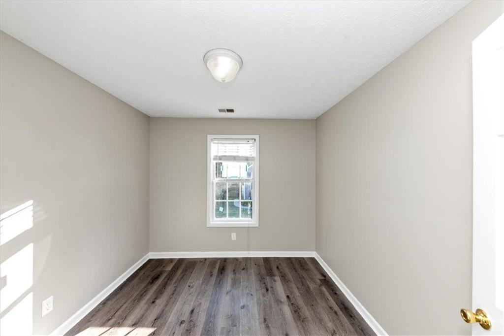 4169 Riverbank Court Decatur, GA 30034 - Photo 17 of 32 an empty room with wooden floor and windows