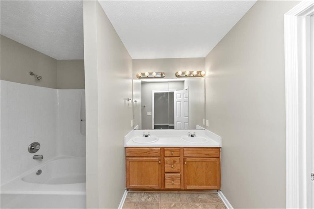 4169 Riverbank Court Decatur, GA 30034 - Photo 24 of 32 a bathroom with a bathtub sink and mirror