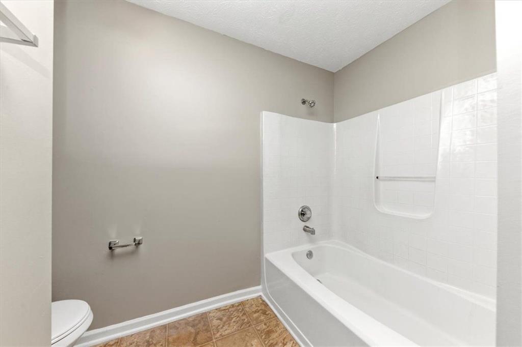 4169 Riverbank Court Decatur, GA 30034 - Photo 25 of 32 a bathroom with a bathtub and a toilet