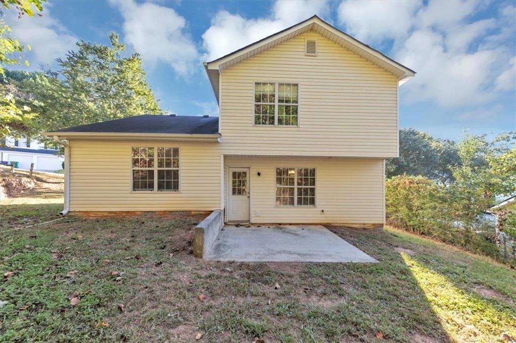 4169 Riverbank Court Decatur, GA 30034 - Photo 29 of 32 a front view of a house with a yard and garage