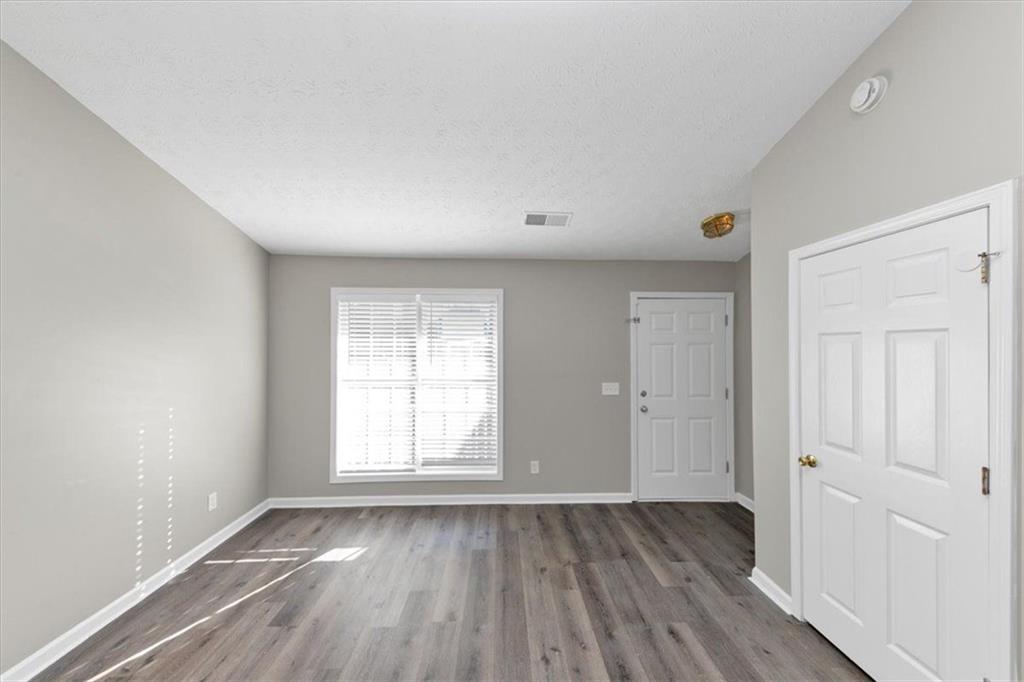 4169 Riverbank Court Decatur, GA 30034 - Photo 3 of 32 an empty room with wooden floor and windows