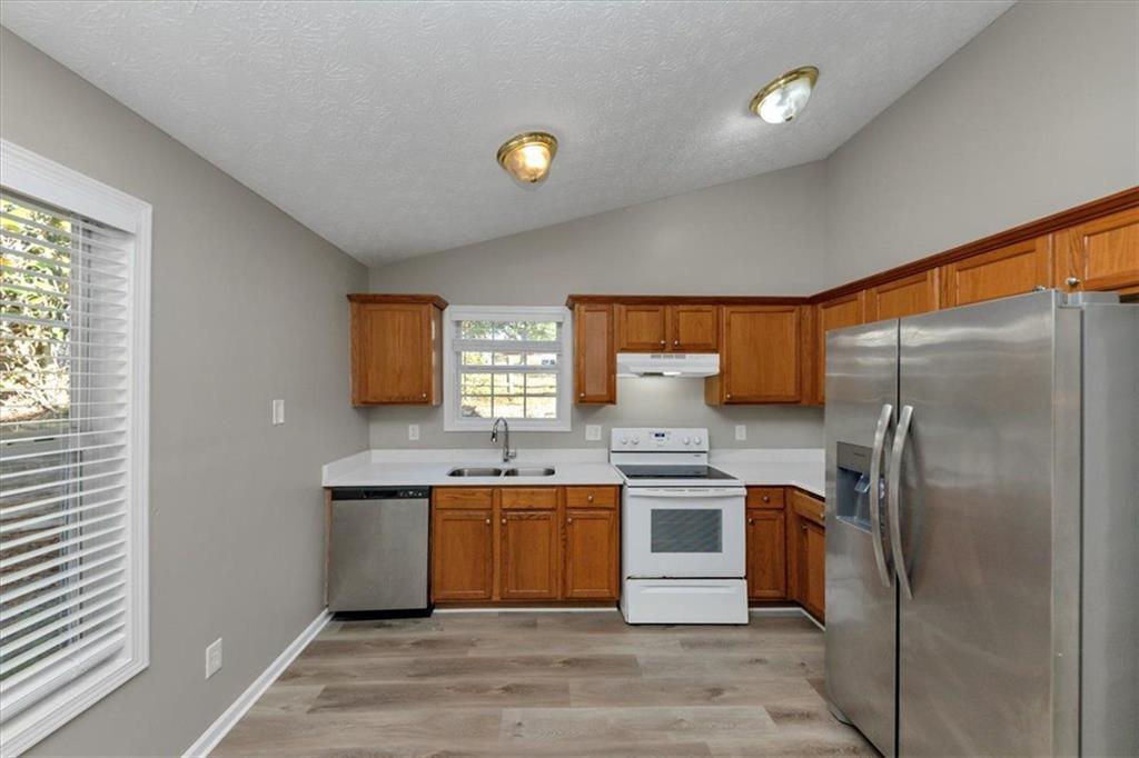 4169 Riverbank Court Decatur, GA 30034 - Photo 9 of 32 a kitchen with a sink a refrigerator and window