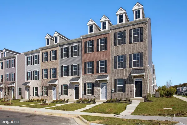 a front view of a residential apartment building with a yard