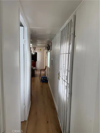 a view of a hallway with a livingroom and a bathroom