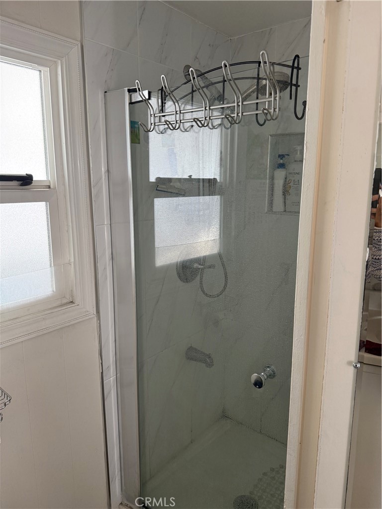 4117 West McFadden Avenue Santa Ana, CA 92704 - Photo 18 of 26 a bathroom with a glass shower door