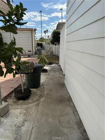 a front view of a house with a tree