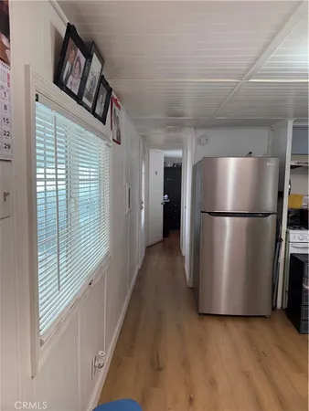 a view of kitchen with furniture and refrigerator