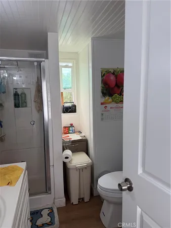 a bathroom with a toilet and a shower