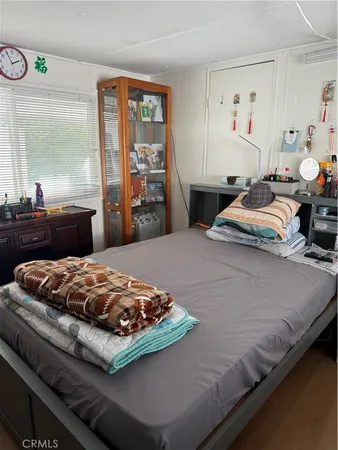 a bedroom with a bed and window