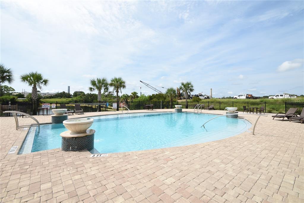 114 Del Palma Drive Palm Coast, FL 32137 - Photo 2 of 63 a view of a swimming pool and lake from nearby houses