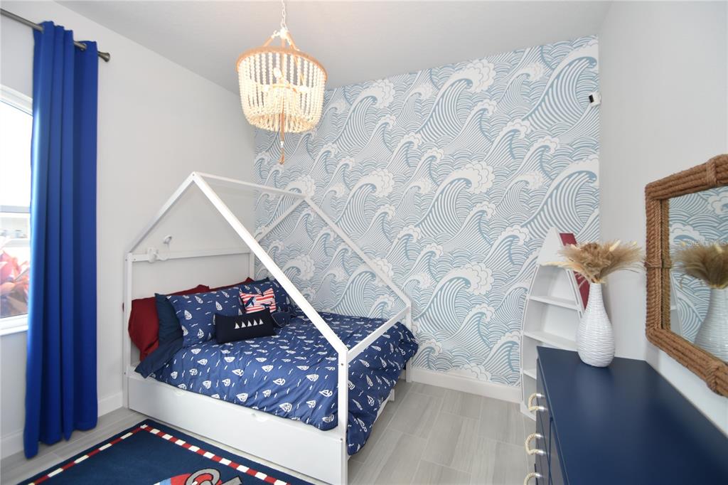 114 Del Palma Drive Palm Coast, FL 32137 - Photo 42 of 63 a living room with furniture and a chandelier