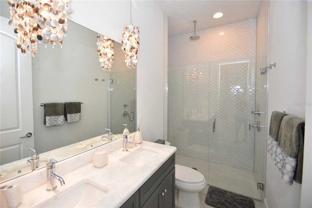 114 Del Palma Drive Palm Coast, FL 32137 - Photo 45 of 63 a bathroom with a sink a toilet and shower
