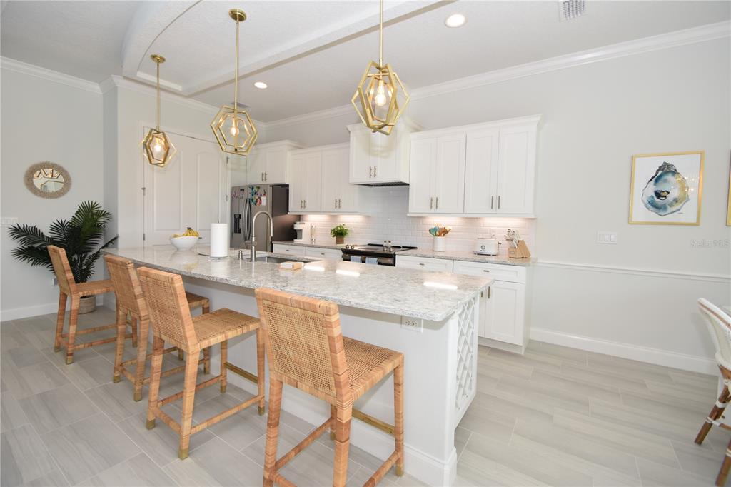 114 Del Palma Drive Palm Coast, FL 32137 - Photo 10 of 63 a kitchen with a dining table a sink and cabinets