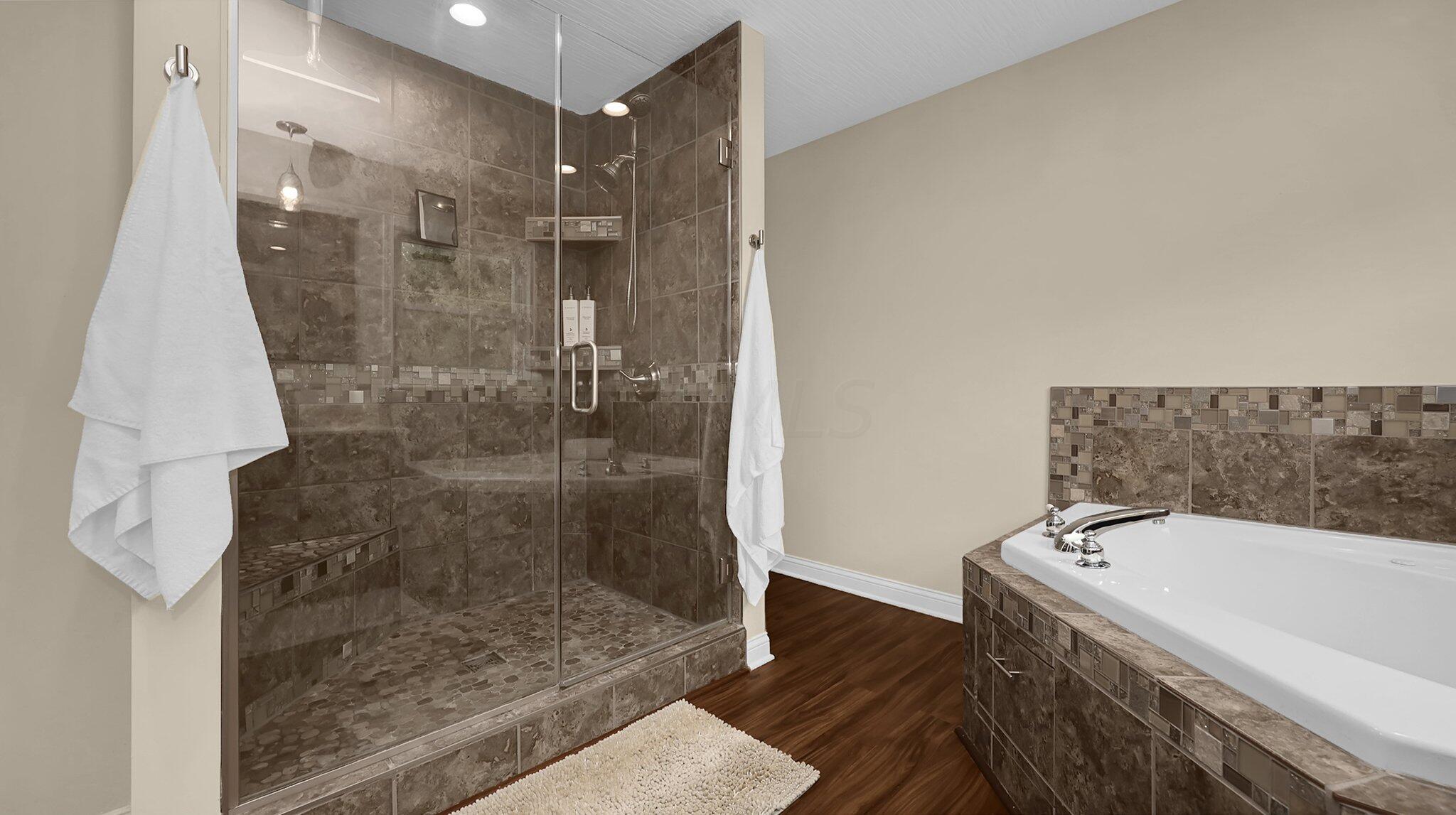 7790 Schott Road Westerville, OH 43081 - Photo 28 of 50 En-suite bathroom with dual vanities, updated lighting, tile surrounds, and lighting-ready for you to enjoy!