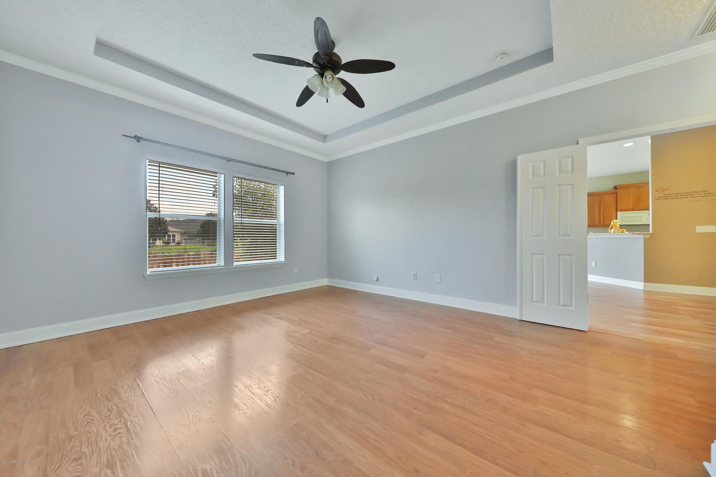 9189 Raptor Drive Jacksonville, FL 32221 - Photo 15 of 23 a view of an empty room with a window and wooden floor
